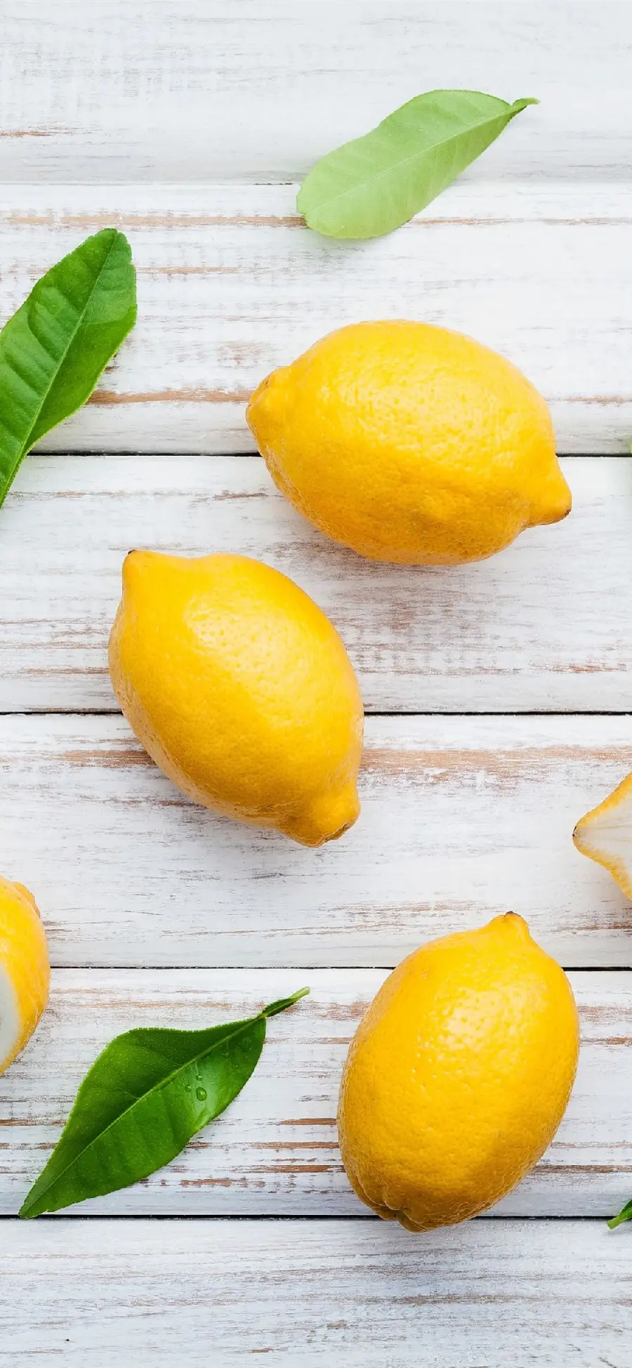 Background photo of beautiful and colorful lemons on a wooden board