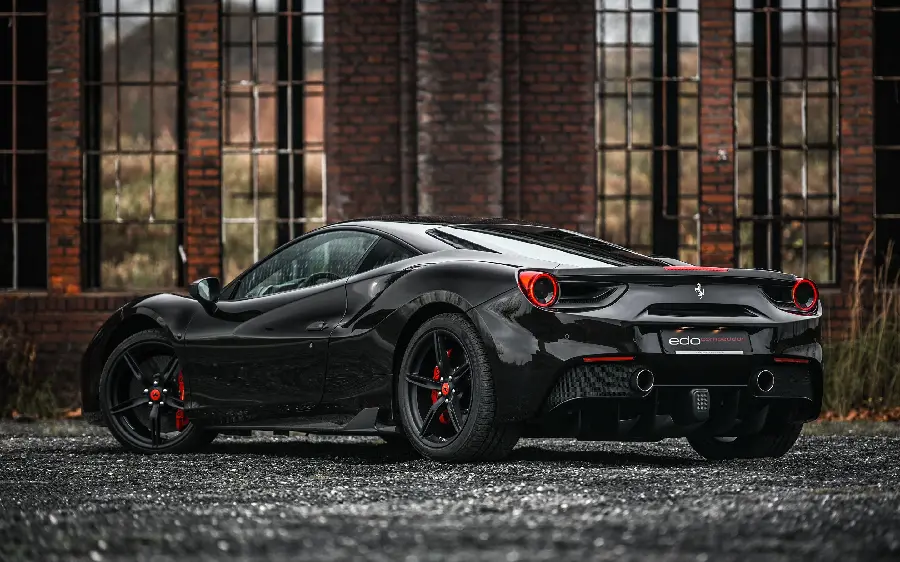 Luxury profile of the black Ferrari 488 Spider with red trim