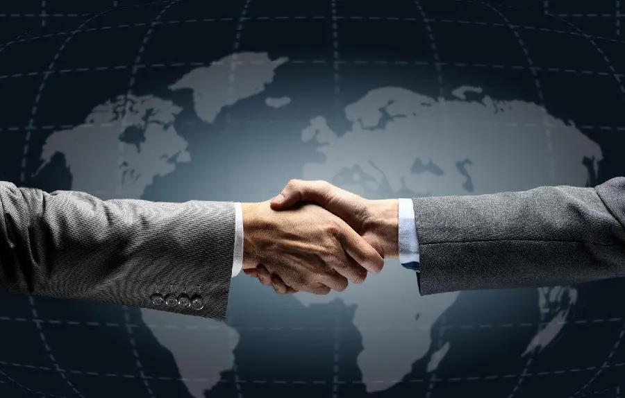 Free image of men shaking hands with a background of the Earth 