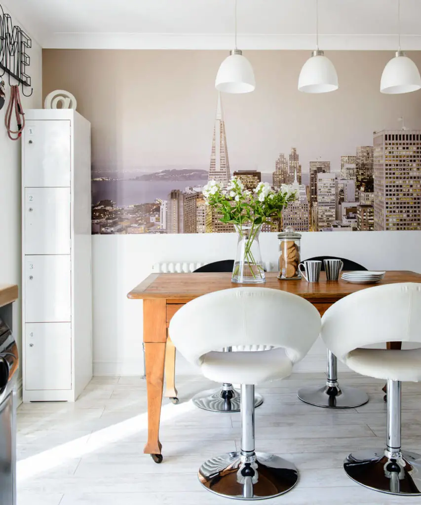A charming background of a white kitchen with a wooden table 