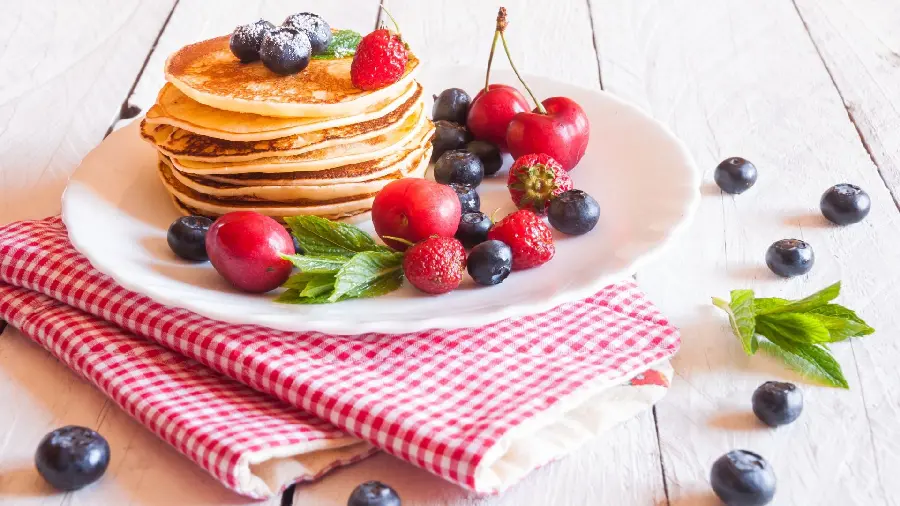 The most viewed image of homemade pancakes decorated with fruit suitable for advertising 