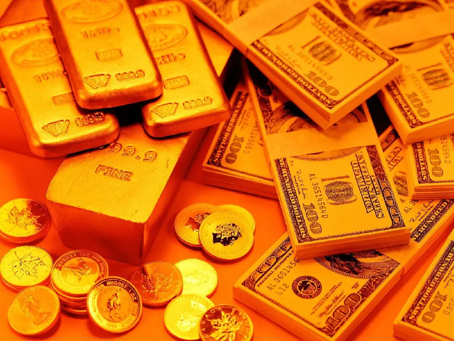 Background photo of gold bars and coins next to bundles of banknotes 