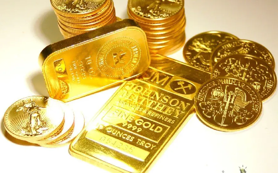 Beautiful gold coins next to some gold bars with a white background 