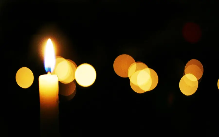 Photo of a bright yellow candle for condolences and sympathy 