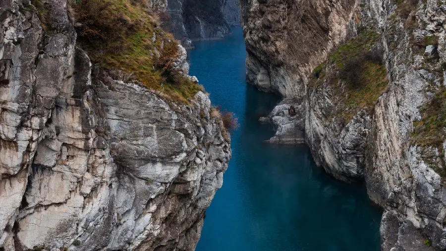 Gorge wallpaper with giant rocks and a river between them for social networks