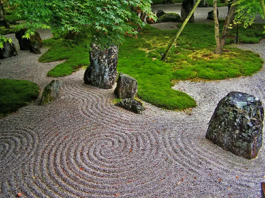 Photo of few and large stones in a Zen garden with a very rich conceptual support
