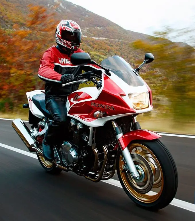 Image of a man riding a Honda CB1300 on a road for printing