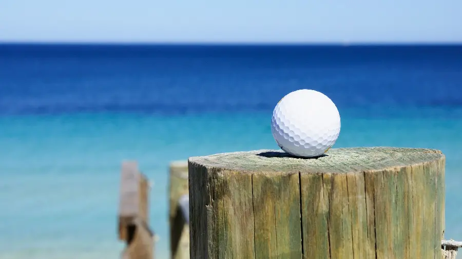 Incredibly beautiful photo of a golf ball on the beach 