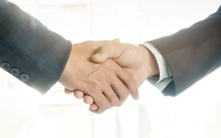 Simple image of two men shaking hands for use in official projects