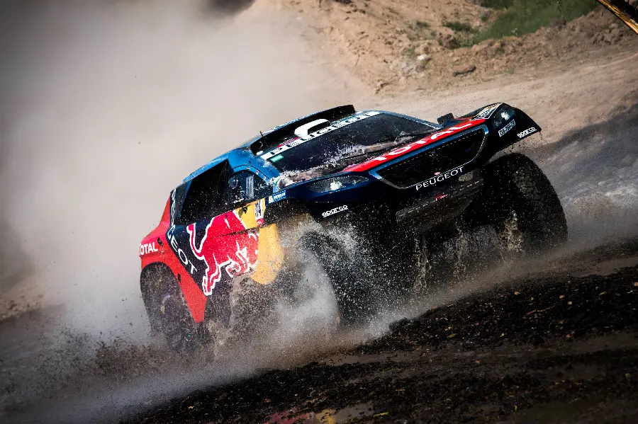 Photo of a fast and luxurious black Peugeot car in the spectacular Dakar Rally series