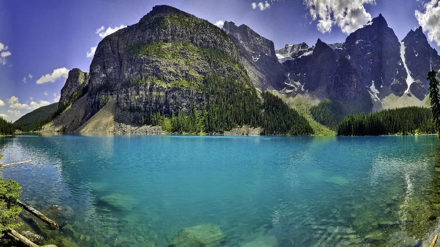 The latest wallpaper of a cool blue lake among lush mountains in 5K quality