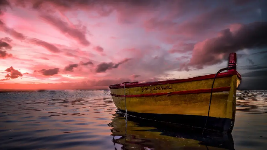 A very beautiful picture of a boat in the sea with a beautiful and unique sky 