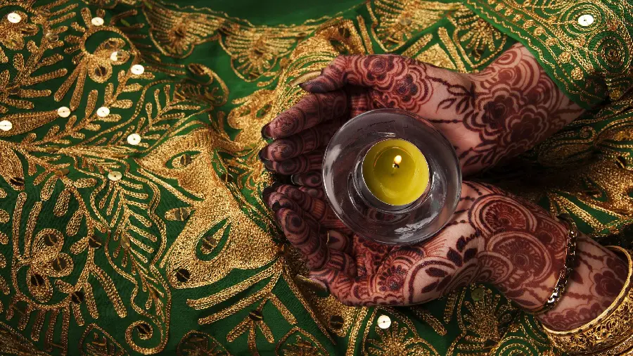 Beautiful decorative model photo of henna on the hand with a designFlowers and leaves in religious ceremonies