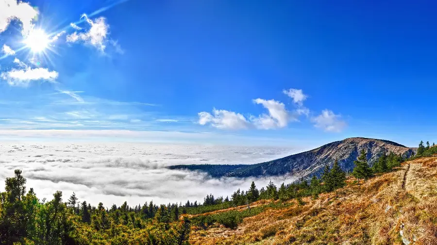 Attractive and spectacular background of the foggy sky with high mountains