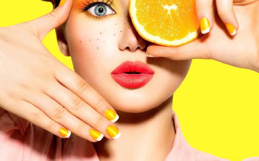 Girly profile picture of a woman with red lipstick and a slice of orange
