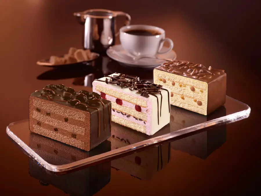 Interesting background of three types of cake slices with different flavors 