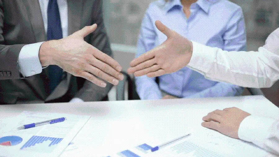 Selected image of handshake and reaching an agreement on a business plan and office project 