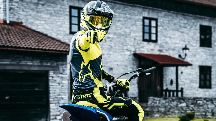 HD Image of Motorcyclist with Helmet and Helmet Expensive yellow black safety helmet
