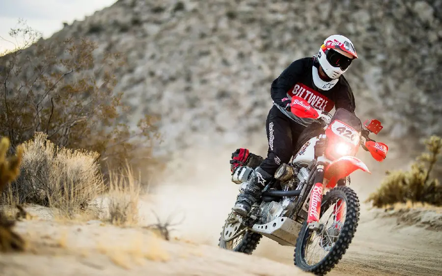 Full HD image of a boy riding a motorcycle in a race with a red and white cover