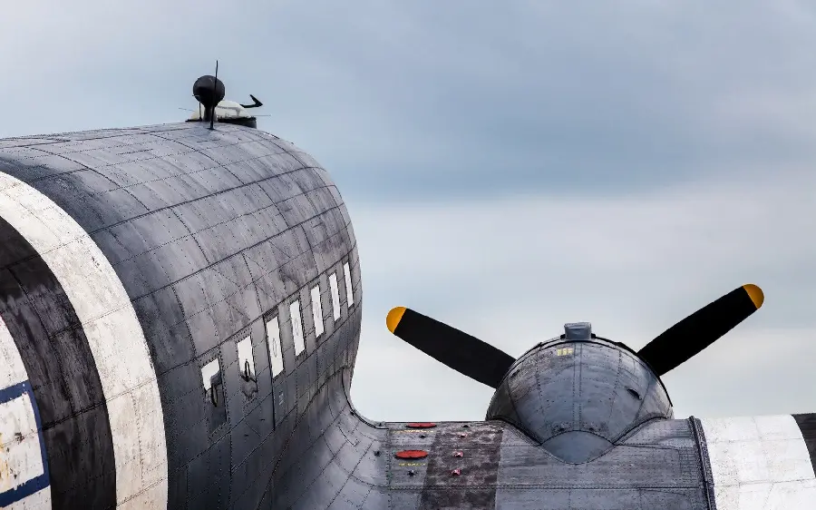 Photo of the wing and body of a giant old plane in black