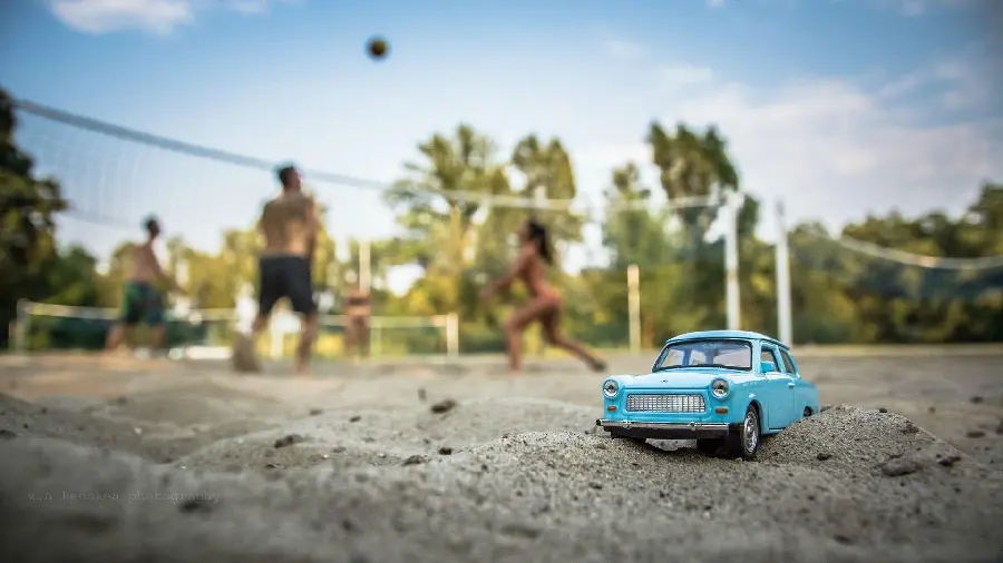 Car image Old miniature on the beach with a blurred background 