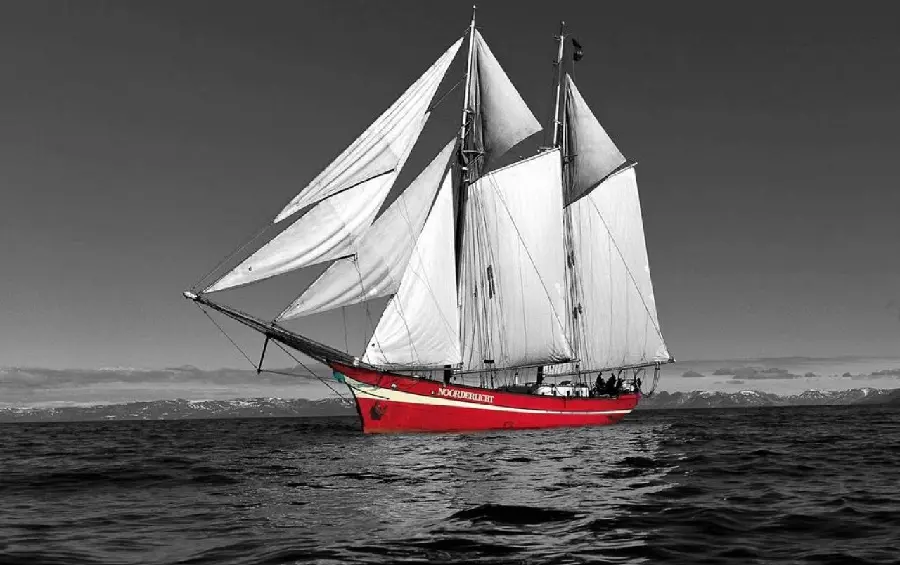 Download wallpaper of a new sailing ship with a red hull suitable for desktop