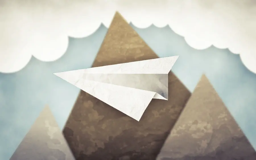 Beautiful and delicate full hd background photo of a paper rocket among clouds and mountains