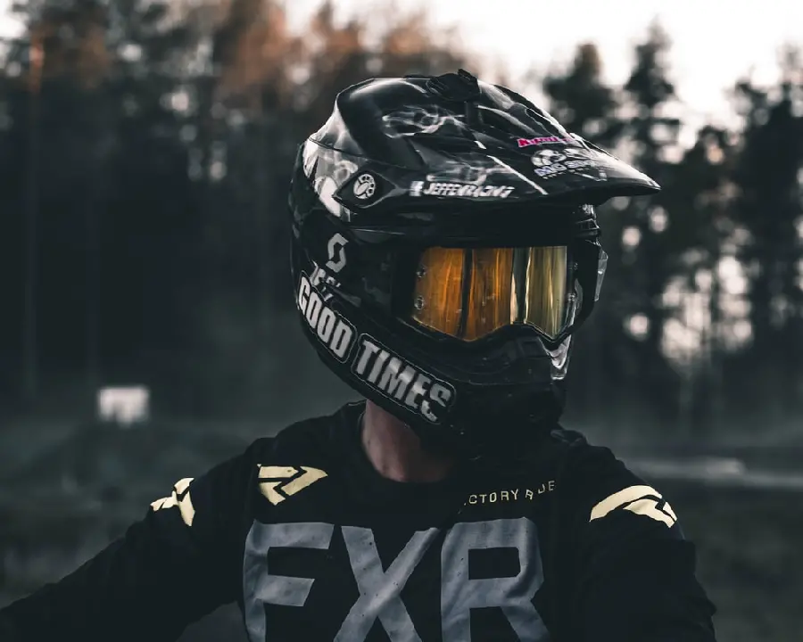 The most visible profile picture of a boy riding a motorcycle with a motocross helmet in the middle of the forest