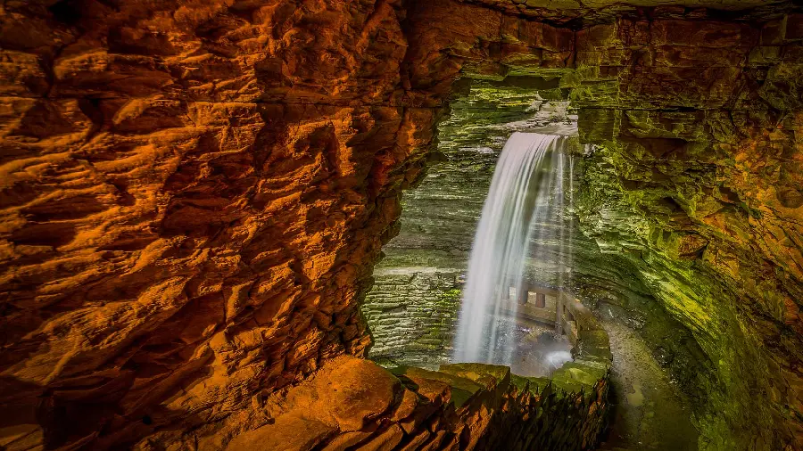 Attractive wallpaper of a heavenly waterfall in a colorful cave for simple-minded people