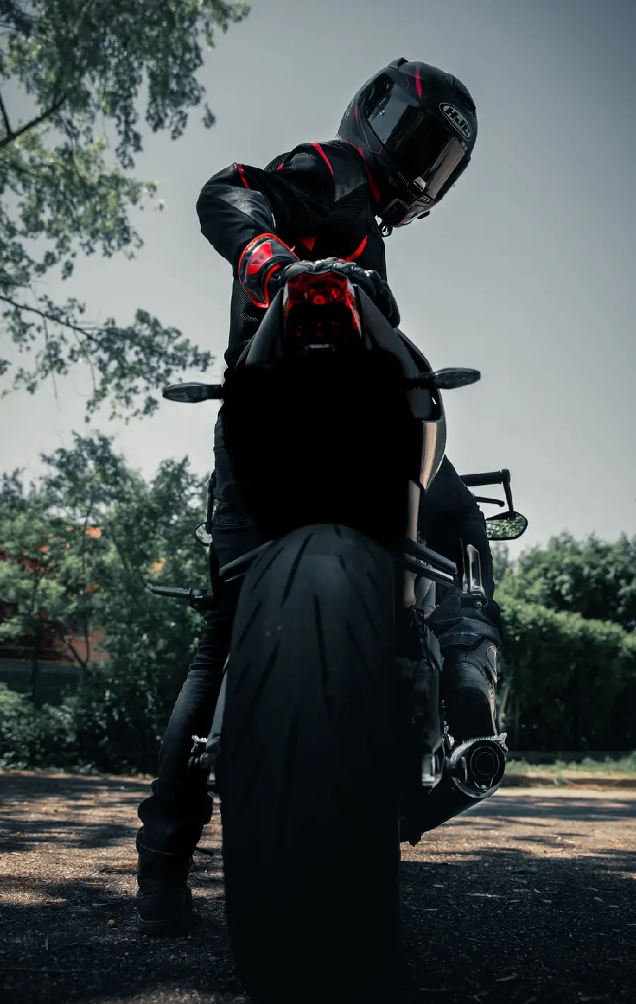 A Masterpiece Photo of a Man Riding a Motorcycle with a Helmet and Special Clothes for a Profile