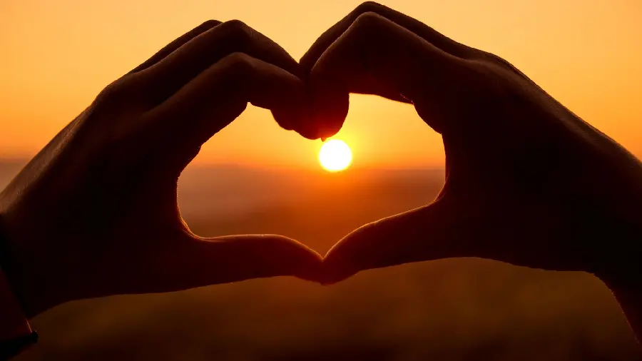 Beautiful Sunset Wallpaper with Heart-shaped Hands for Windows