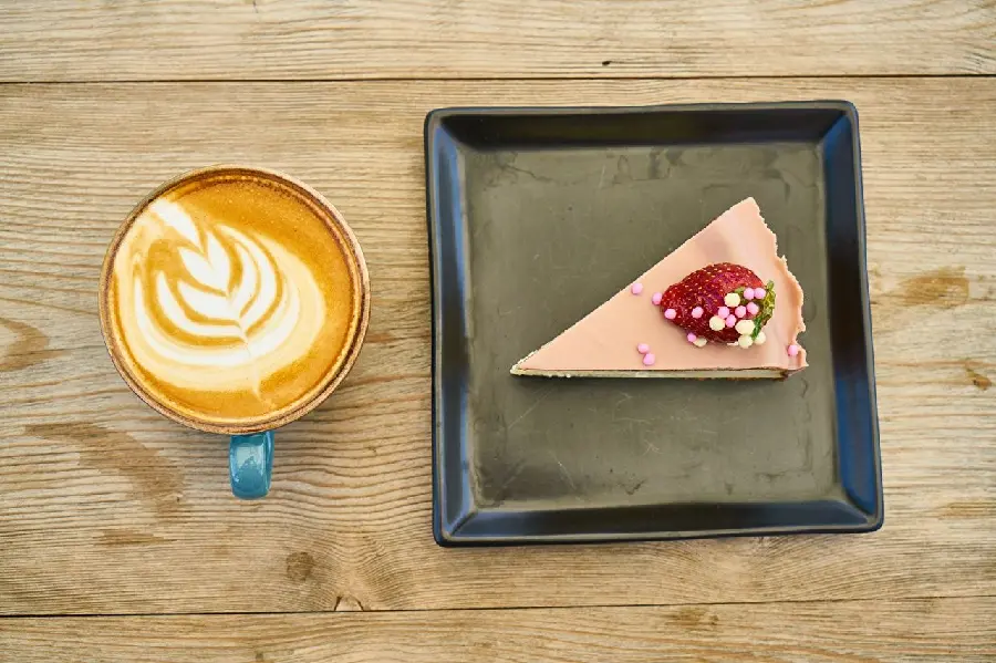 Interesting background of a cut piece of strawberry cake and a delicious art