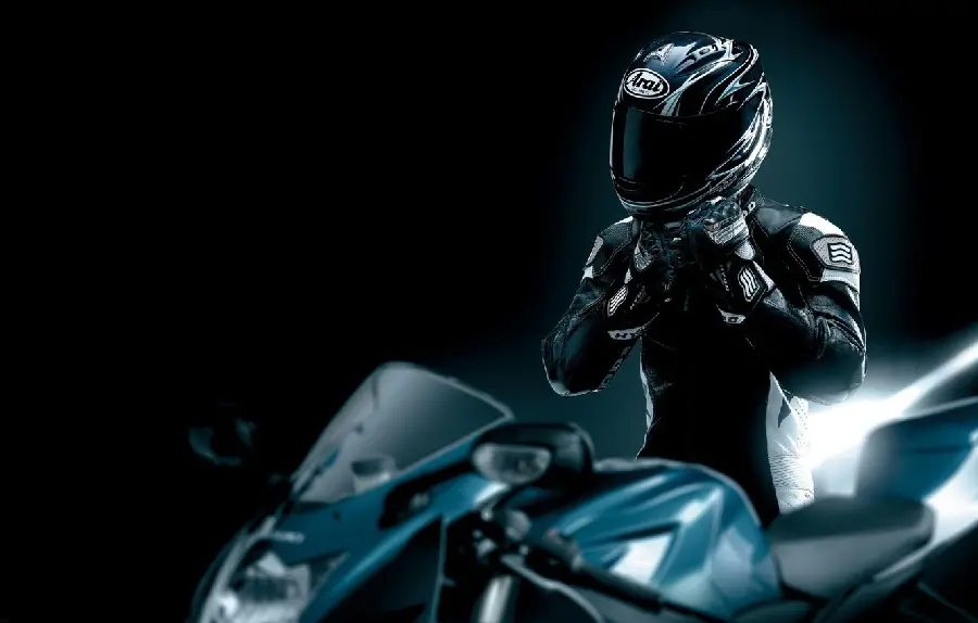 Super stylish image of a man with a helmet and motorcycle clothing with a black theme