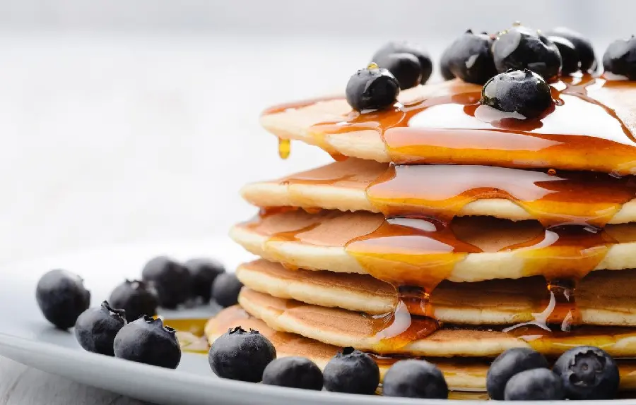 Download the highest quality pancake photo decorated with blueberries and honey 