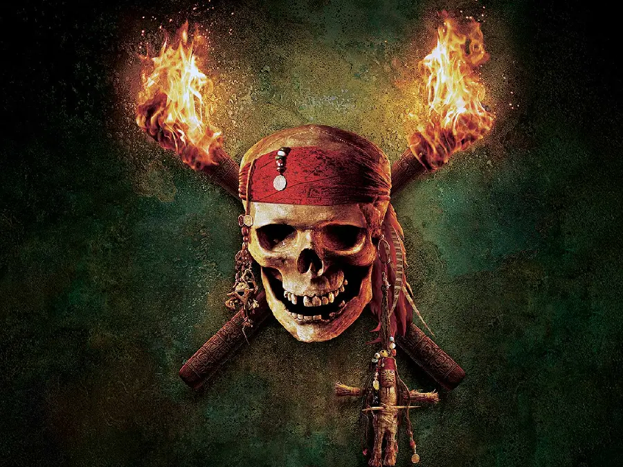 Photo of pirate skull with two lit torches on an old wall