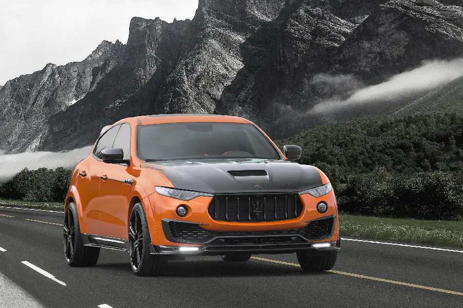 Amazing photo of an orange car on a mountain road in excellent quality