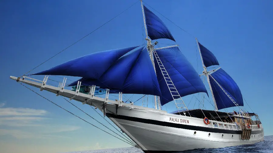 Incredibly beautiful wallpaper of a large boat with blue carbon sails 