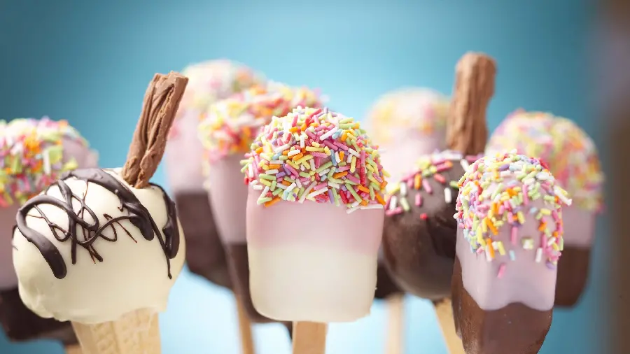 A delicious photo of a popsicle with colorful truffles ready to be used in a poster