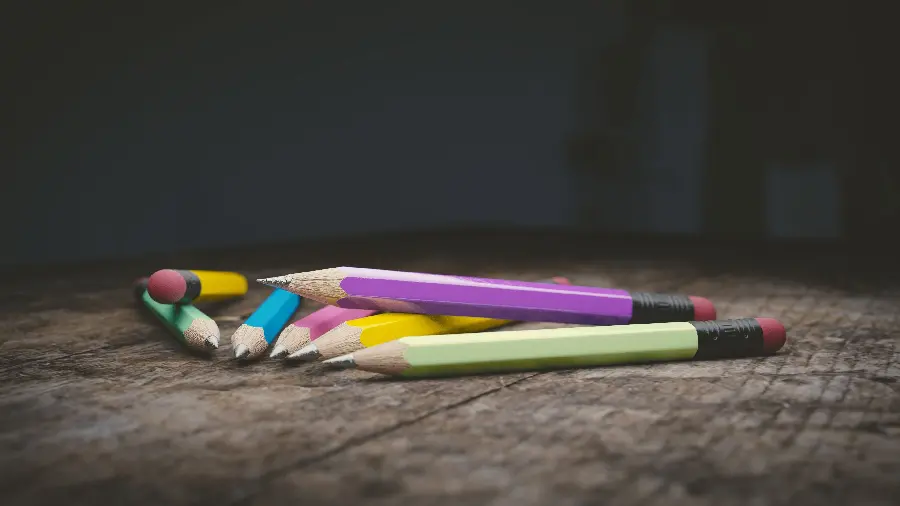 A charming background of beautiful black pencils with colorful colored coating 