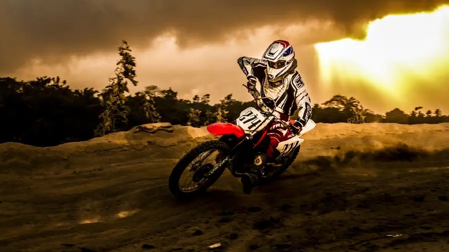 Exciting Background of Attractive Motorcycle Riding in a Desert Race at Sunset