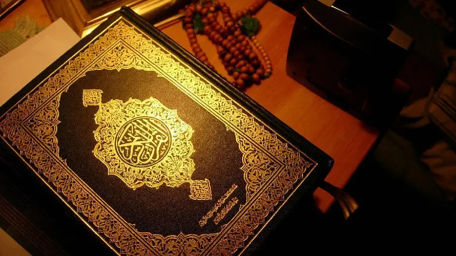 Amazing picture of the Holy Quran with yellow light shining on it 