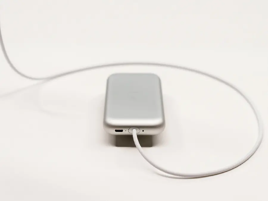 Photo of the battery of the Apple mixed reality headset with the cable connected to it in spectacular quality 2023