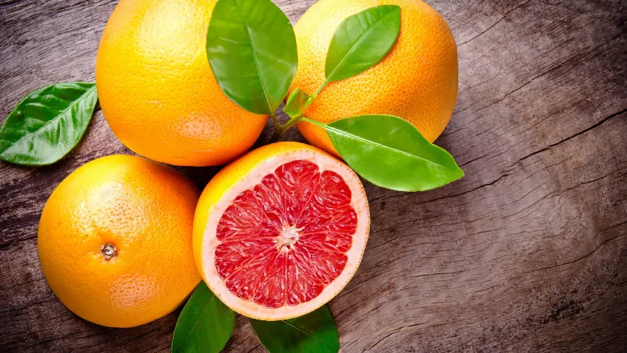 Download a background image of a grapefruit fruit that looks like an orange