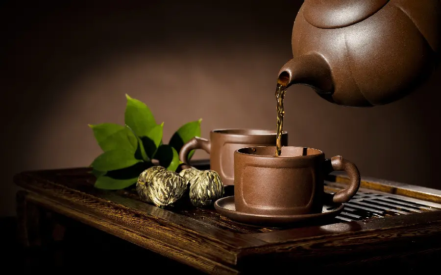 Beautiful background of a wooden cup and teapot serving tea