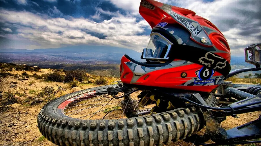 New photo of a red helmet and a motorcycle in the desert for a profile 