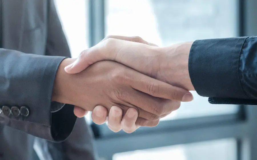 High quality image of a negotiation agreement and handshake between two people 