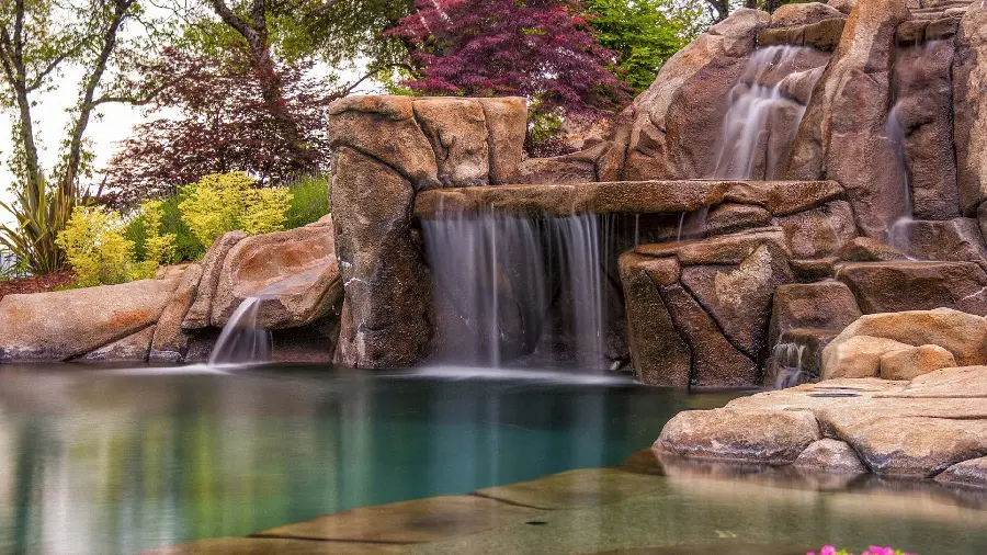 Clarifying and heavenly waterfall wallpaper surrounded by spring plants for desktop