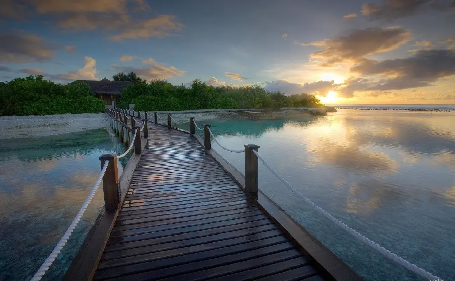 Background of the endless blue sea and a bright sunrise