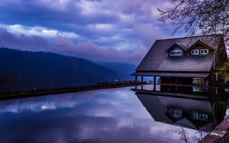 Amazing image of a wooden hut by the water and sunrise
