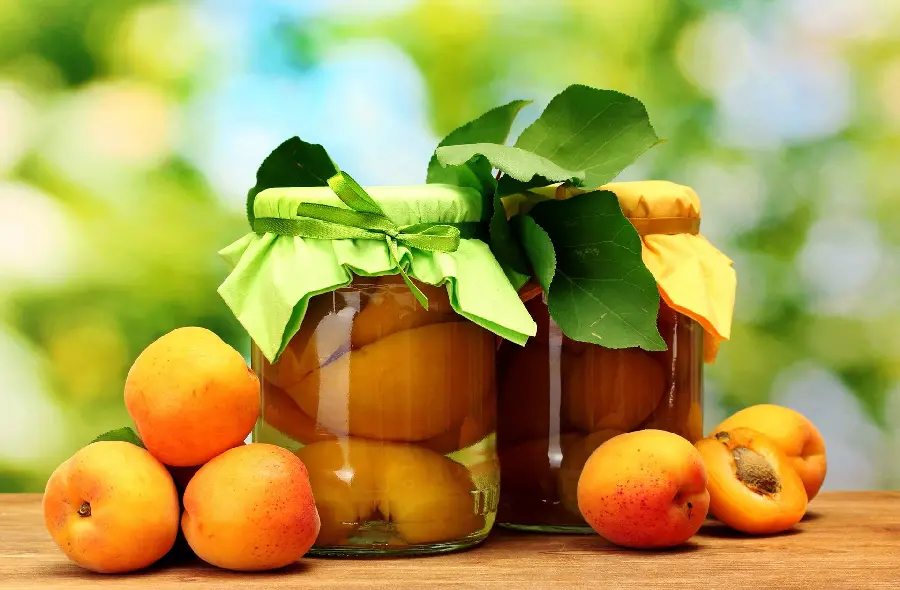 Unique photo of apricot compote in beautiful jars 
